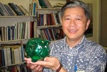 Michael Cheang holding piggy bank
